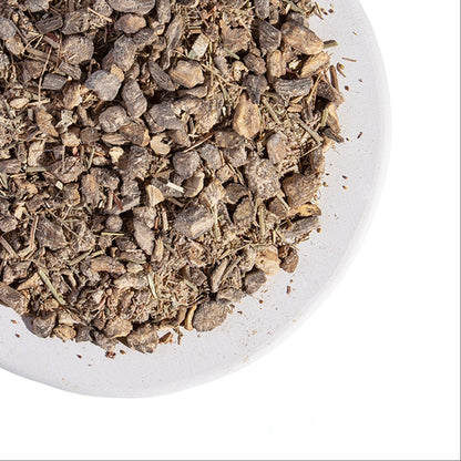 Dried herbs on a white plate with Grassroots Herb Supply logo.