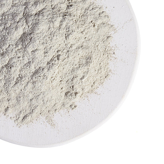 Powdered substance on a white plate with Grassroots Herb Supply logo.